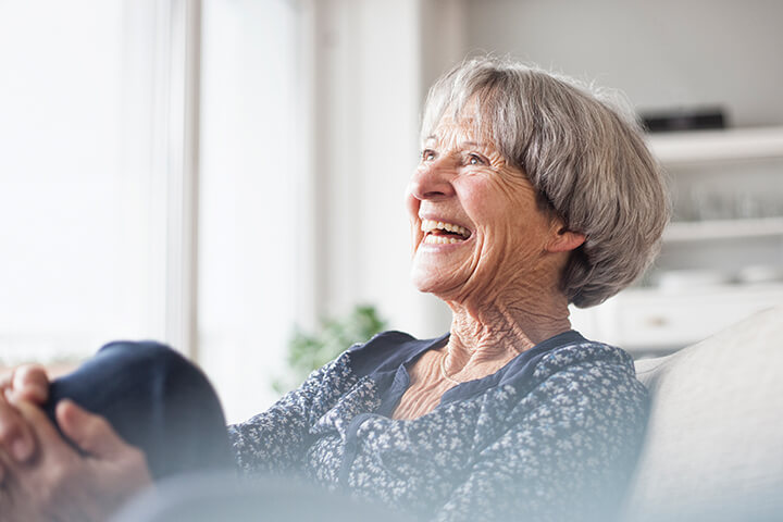 Elderly woman laughing at Life Care Gaynes Park Suites