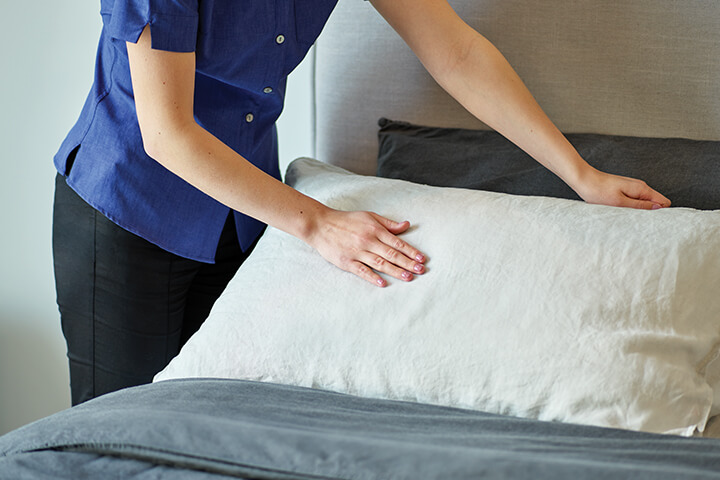 Staff member making a bed, Life Care Gaynes Park Suites